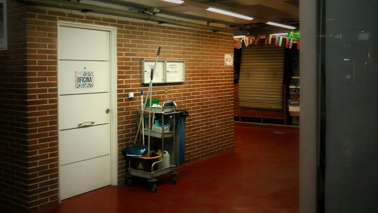 Commercial janitorial staff cleaning an office at night