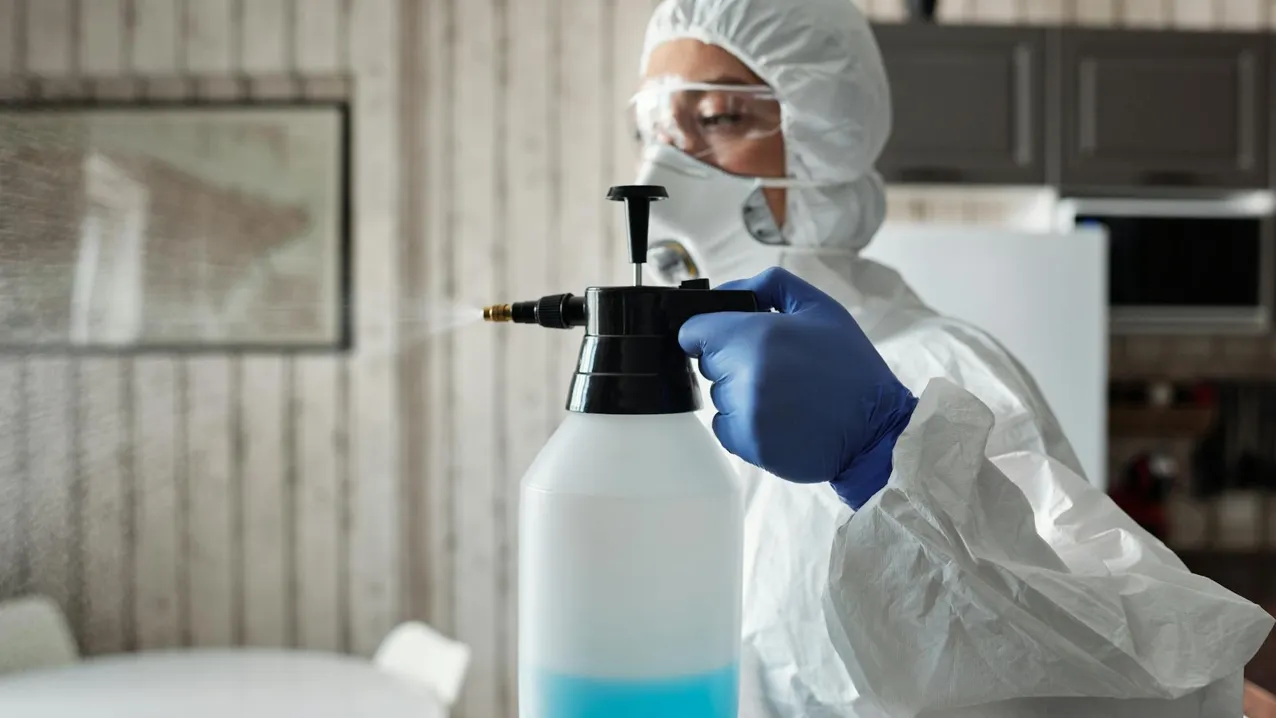 Pest control technician performing treatment in residential home