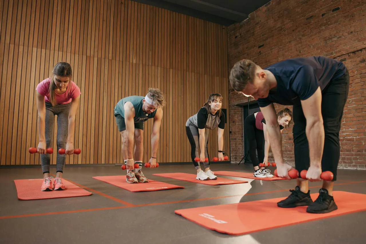 Group yoga class in a sunlit boutique fitness studio