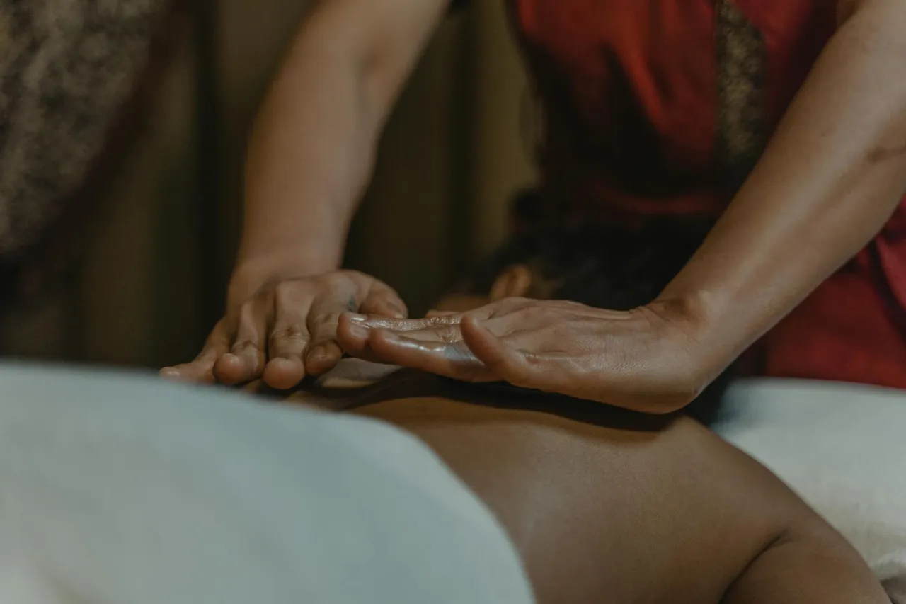 Massage therapist performing a treatment on a client